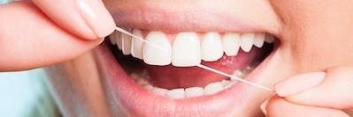 woman flossing her teeth in charleston sc