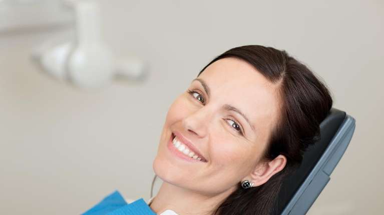 A white-toothed woman in a dental chair smiling in Mount Pleasant