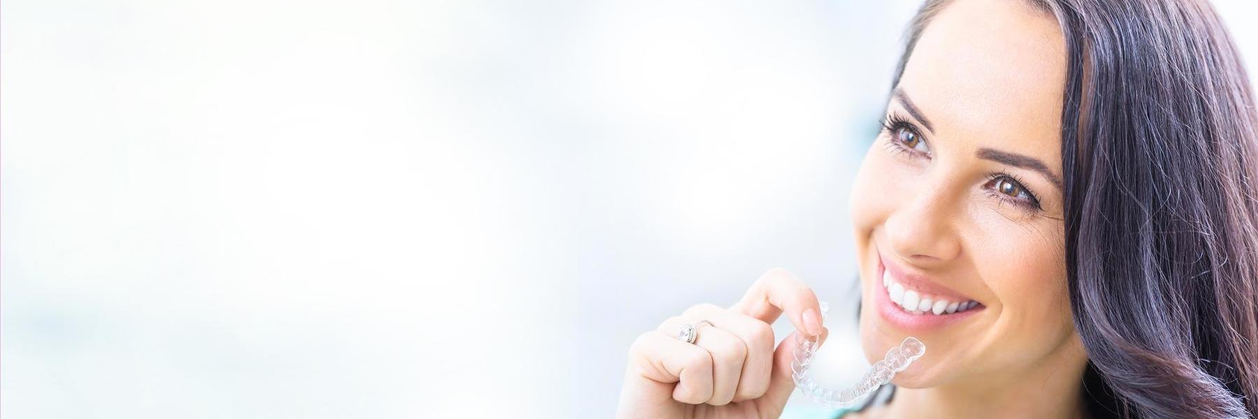 woman putting on invisalign in charleston sc